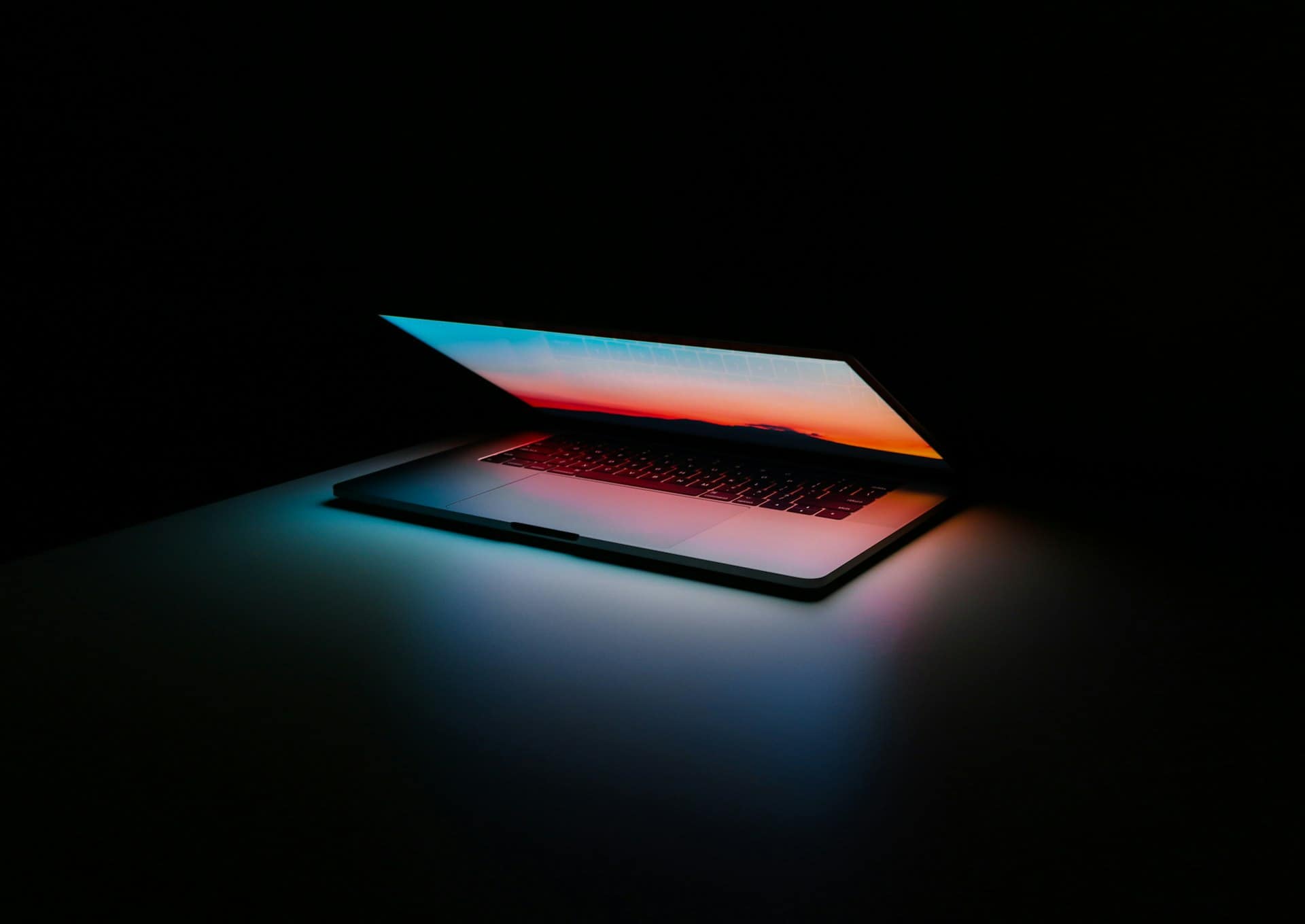 Dark engineering workspace with laptop