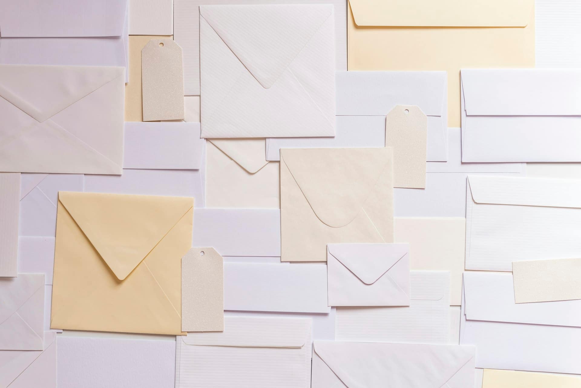 Envelopes and paper tags laid out in an orderly grid
